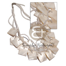 3 graduated rows of pearl white glass