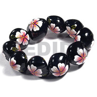 elastic black kukui nut with back to back white flower with pink y