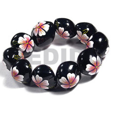 elastic black kukui nut with back to back white flower with pink y
