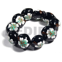 elastic black kukui nut with back to back white flower with pastel